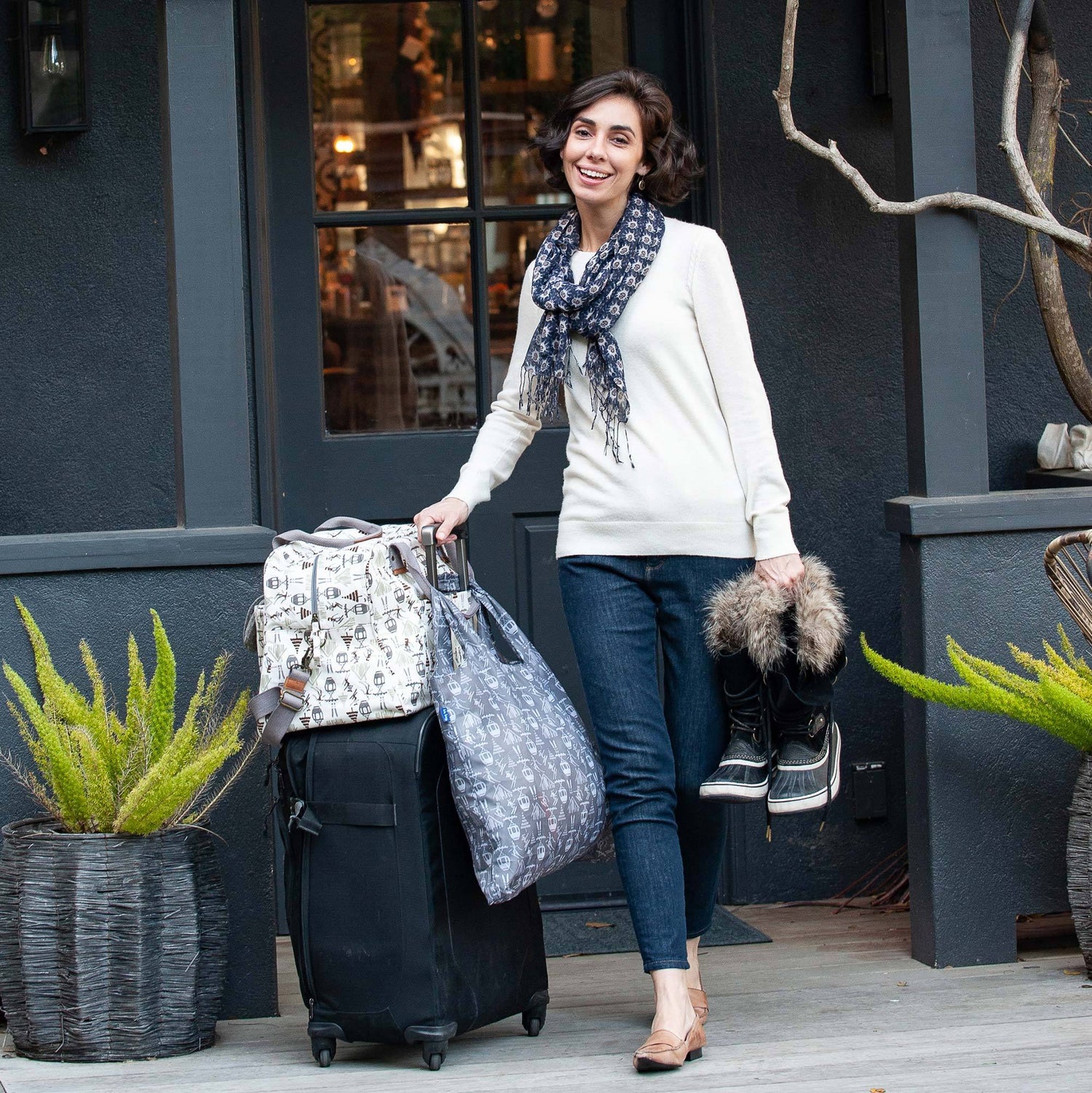 woman traveling with weekender bag and scarf
